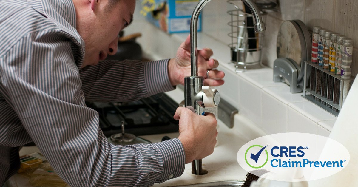 man fixing sink