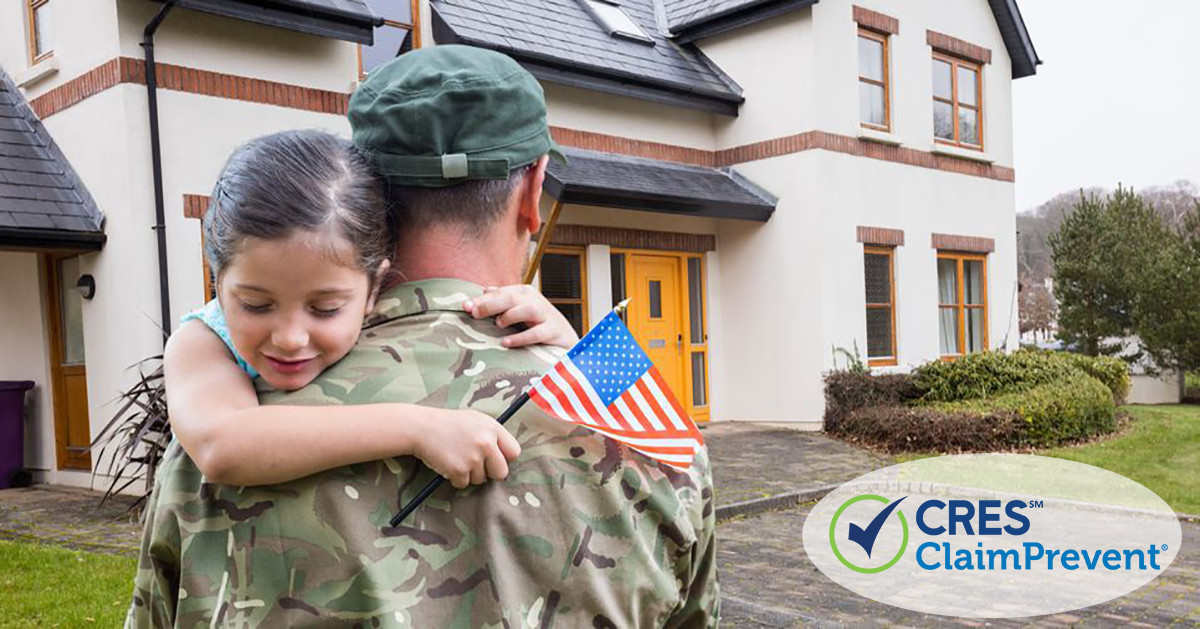 man and daughter with flag in front of house