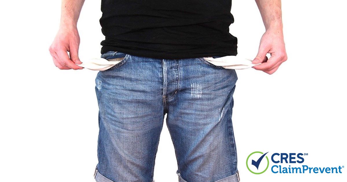 man pulling empty pockets out of shorts