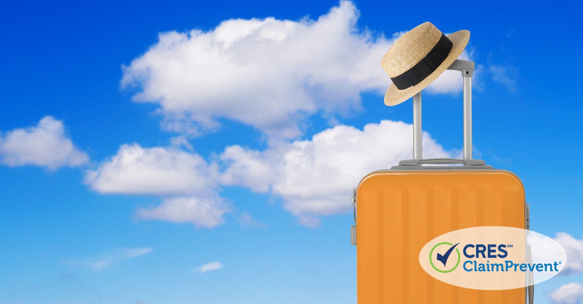 blue skies hat hanging from orange suitcase