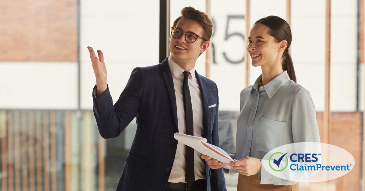 man and woman standing together with papers