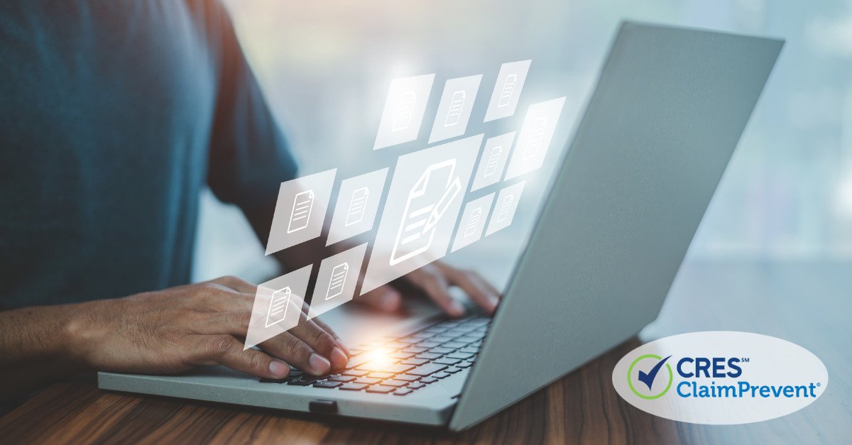 man typing on lap top with document images