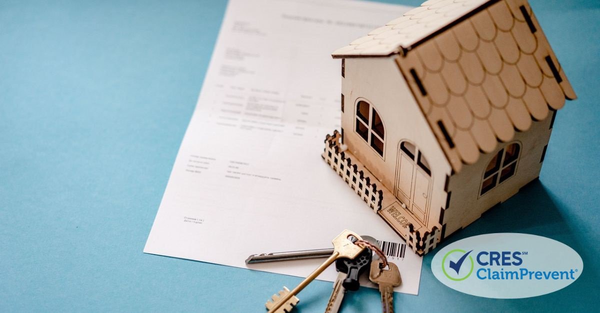 paper with wood house figure and keys on top