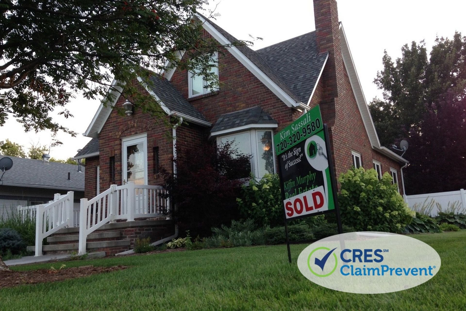 brick house with sold sign in yard